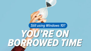 Hand holding an hourglass against a blue background with the bold promo text asking about Windows 10 upgrades: 'Still using Windows 10? You're on borrowed time'.
